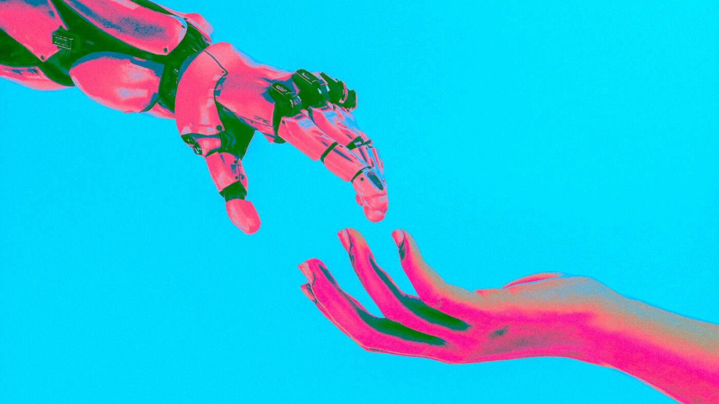 Robot and human hands reaching toward each other, symbolizing AI-assisted content authoring